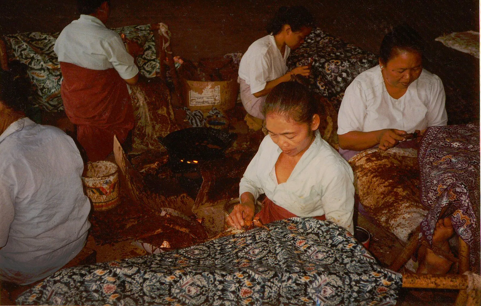 Indonesian batik craftswomen in Yogyakarta Java applying wax resist patterns with tjanting tools — Indonesian batik is inscribed on UNESCO's Representative List as traditional craftsmanship, the fifth of the five domains defined by Article 2.2 of the 2003 Convention for the Safeguarding of the Intangible Cultural Heritage