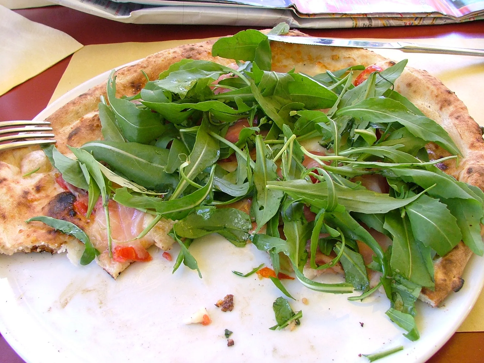 Classic Neapolitan pizza from Naples with wood-fired crust — the tradition of the Neapolitan pizzaiuolo (Art of Neapolitan Pizzaiuolo, File 01595) was inscribed on UNESCO's Representative List in 2017, recognizing the craft knowledge of dough-stretching, wood-fired oven management, and the mestre-apprentice transmission chain as living intangible cultural heritage