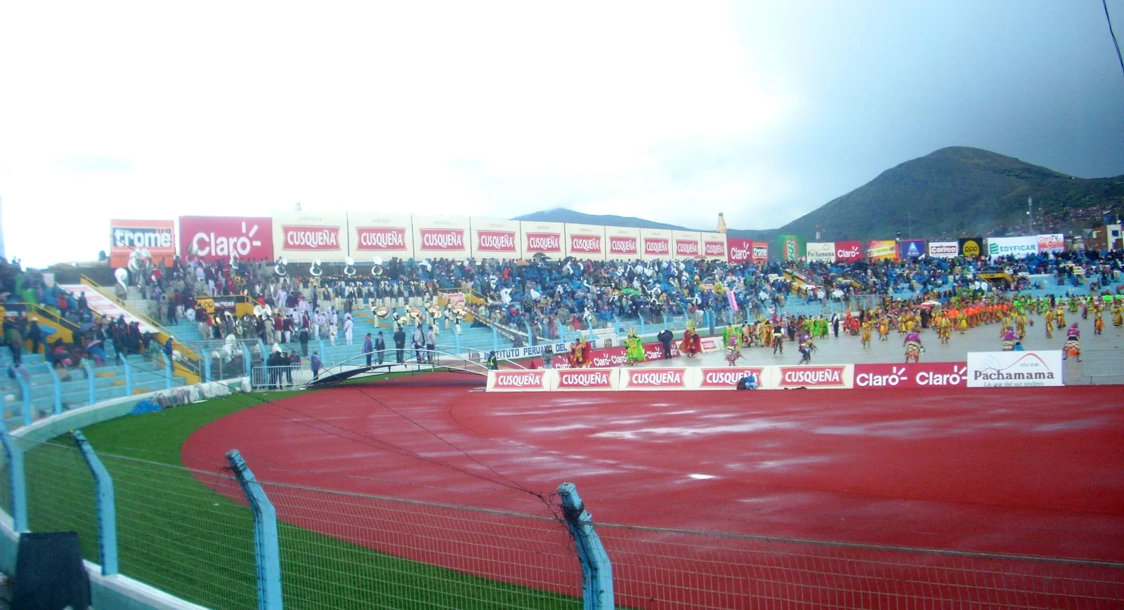 Large parade of costumed dance troupes at Festivity of Virgen de la Candelaria Puno Peru stadium — UNESCO Representative List Intangible Cultural Heritage of Humanity 2014