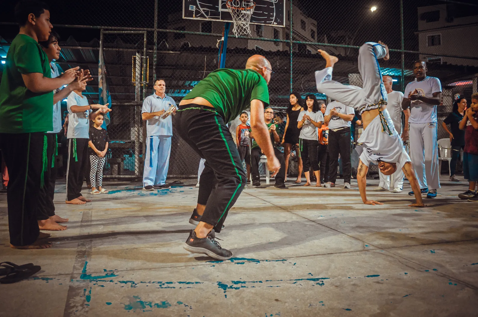 Traditional capoeira roda at Engenho da Rainha community space in Brazil — the circle formation that UNESCO inscribed as File 00892 in 2014, recognizing capoeira as the intangible cultural heritage element most explicitly linked to the memory of resistance to historical oppression