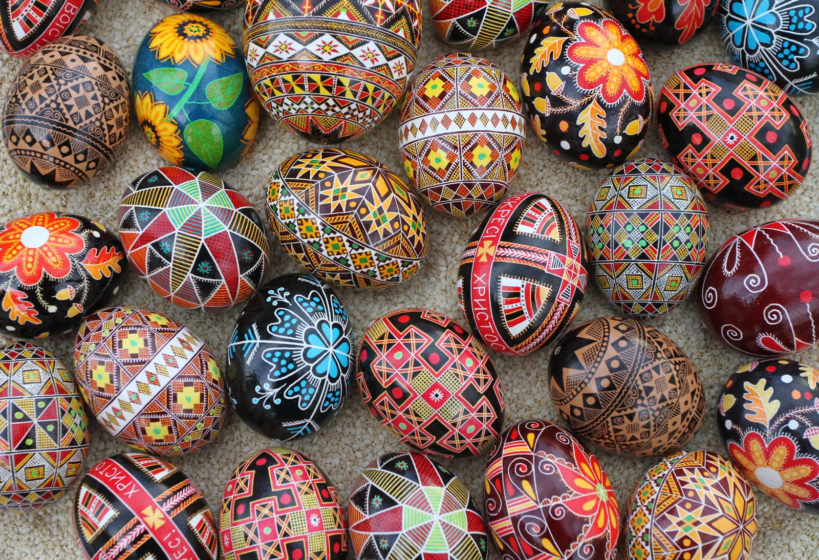 Collection of traditional Ukrainian Pysanka Easter eggs decorated with wax-resist kistka technique showing intricate geometric solar and floral patterns — UNESCO Representative List Intangible Cultural Heritage of Humanity 2024