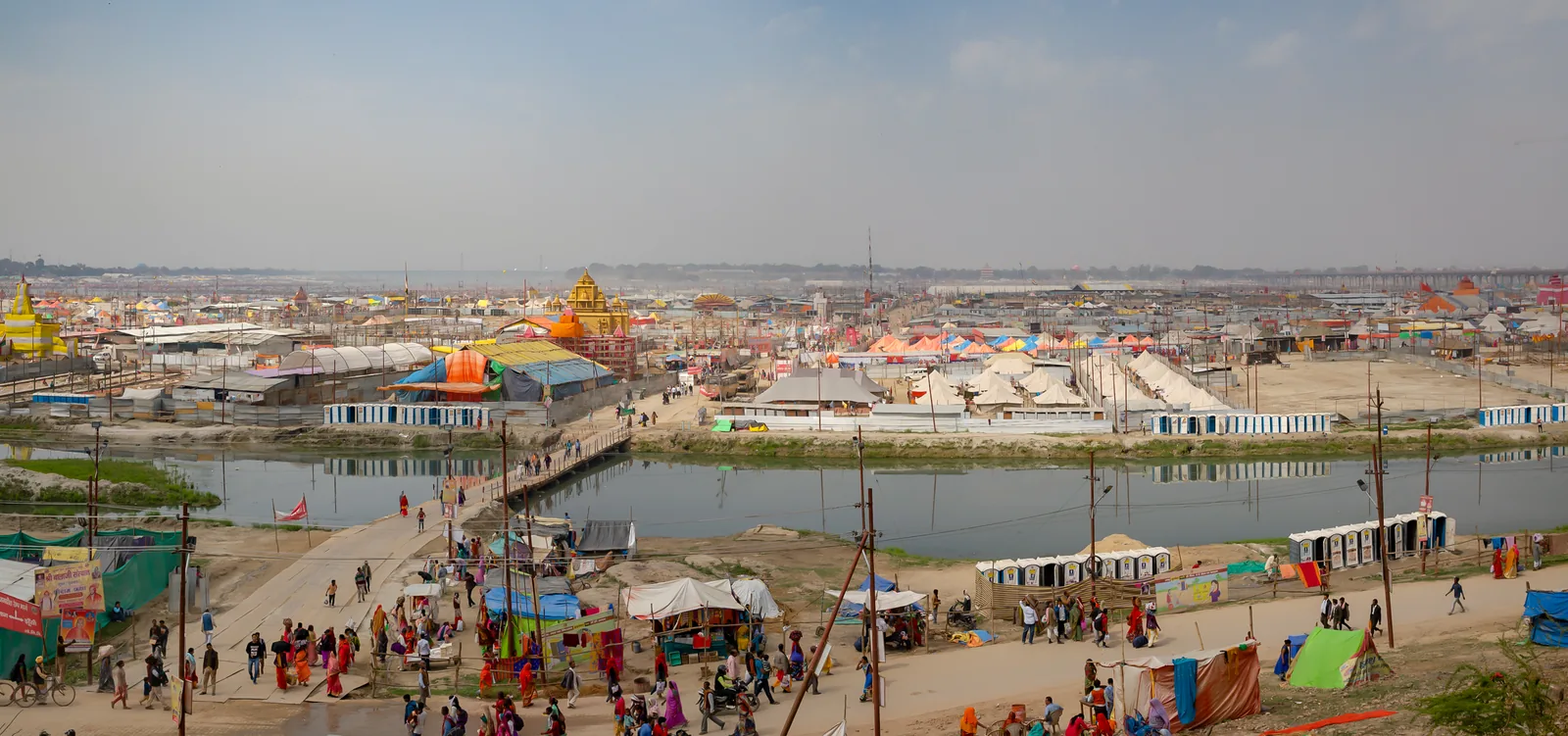 Elevated panoramic view of the Kumbh Mela 2019 at Prayagraj showing the Sangam (Triveni Sangam) river confluence and the vast tent city — Prayagraj is the only site that hosts the Maha Kumbh Mela, held once every 144 years