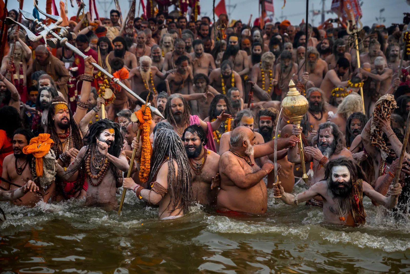 Naga Sadhus from the akharas performing the Shahi Snan (royal bathing) ritual at Kumbh Mela — UNESCO's 2017 inscription covers the akhara tradition organized by Adi Shankaracharya in the 8th century CE as the institutional core of the Kumbh