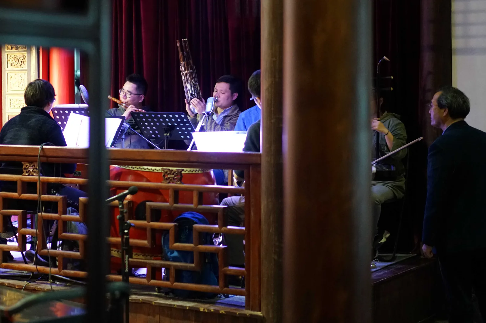 Jiangsu Provincial Kunqu Opera House orchestra performing backstage with dizi bamboo flute, suona, and erhu in a traditional wooden theater — the dizi transverse flute is the defining accompanying instrument of Kunqu's distinctive shuimo qiang vocal style, performed in Zhongzhou rhyme