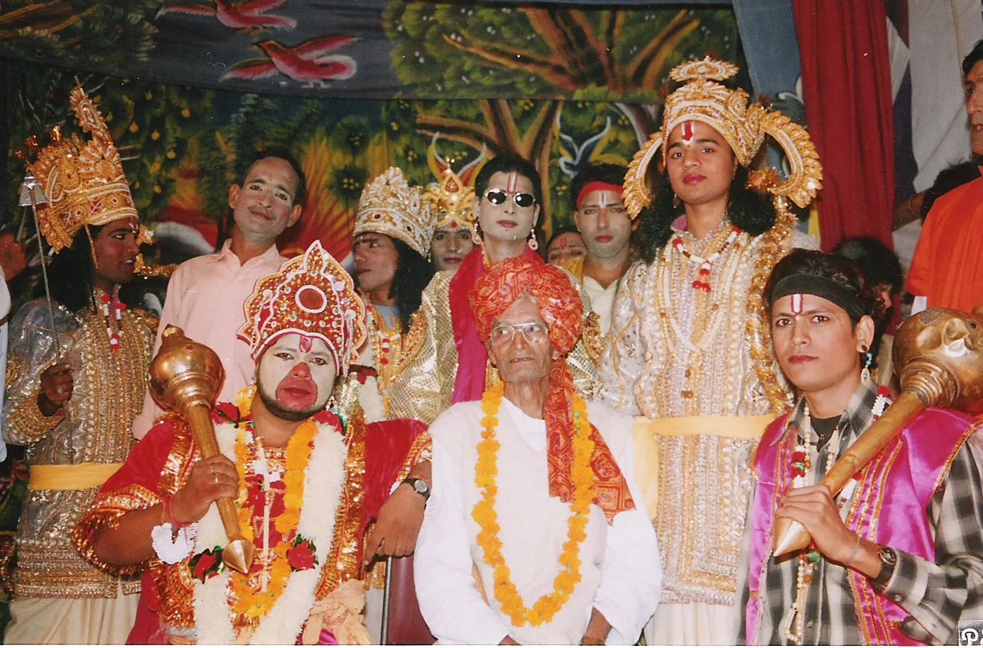 Ramlila troupe group photograph showing Svarupas — performers embodying divine characters including Hanuman (red face, mace) and Rama (gold crown) — with the troupe director (Vyasi) in traditional Ramlila performance, the UNESCO-inscribed intangible cultural heritage of India (File 00110, 2008)