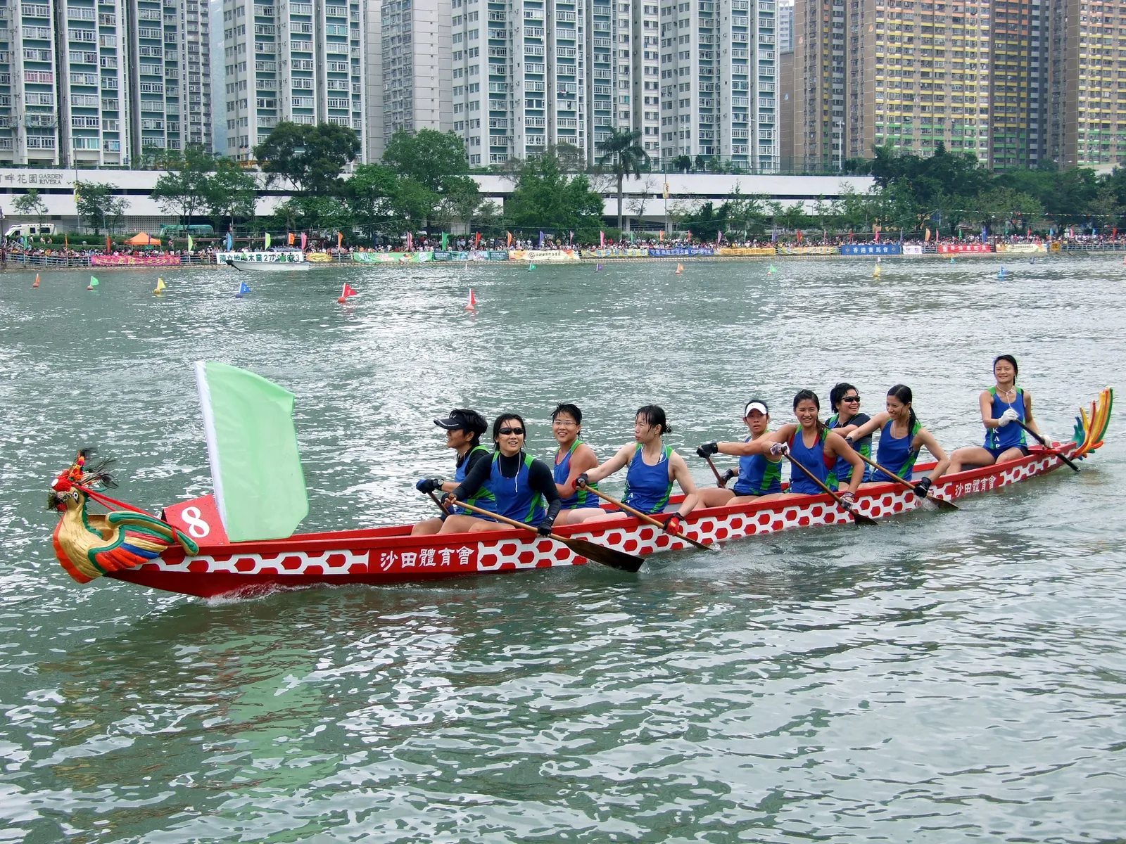 Women's dragon boat team paddling at the Shatin Dragon Boat Festival in Hong Kong's Shing Mun River — the Dragon Boat Festival (Duanwu, UNESCO File 00225, 2009) was part of China's 2009 batch of 22 ICH inscriptions, honoring the poet Qu Yuan through racing, zongzi, and river ritual