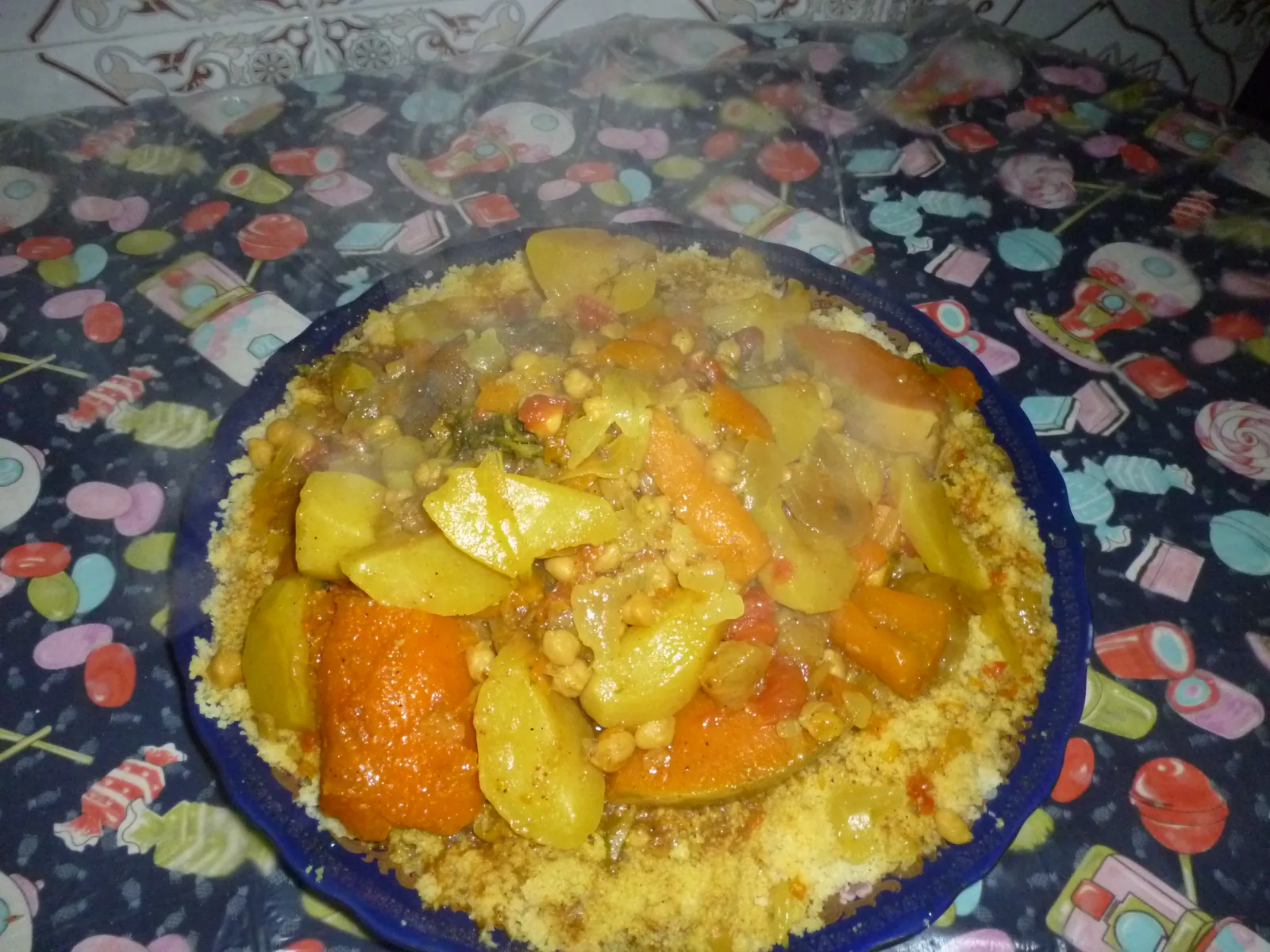 Moroccan couscous with vegetables in a traditional blue dish — the knowledge and practice of couscous preparation across the Maghreb is part of UNESCO's intangible cultural heritage food list (File No. 01426, inscribed 2020)