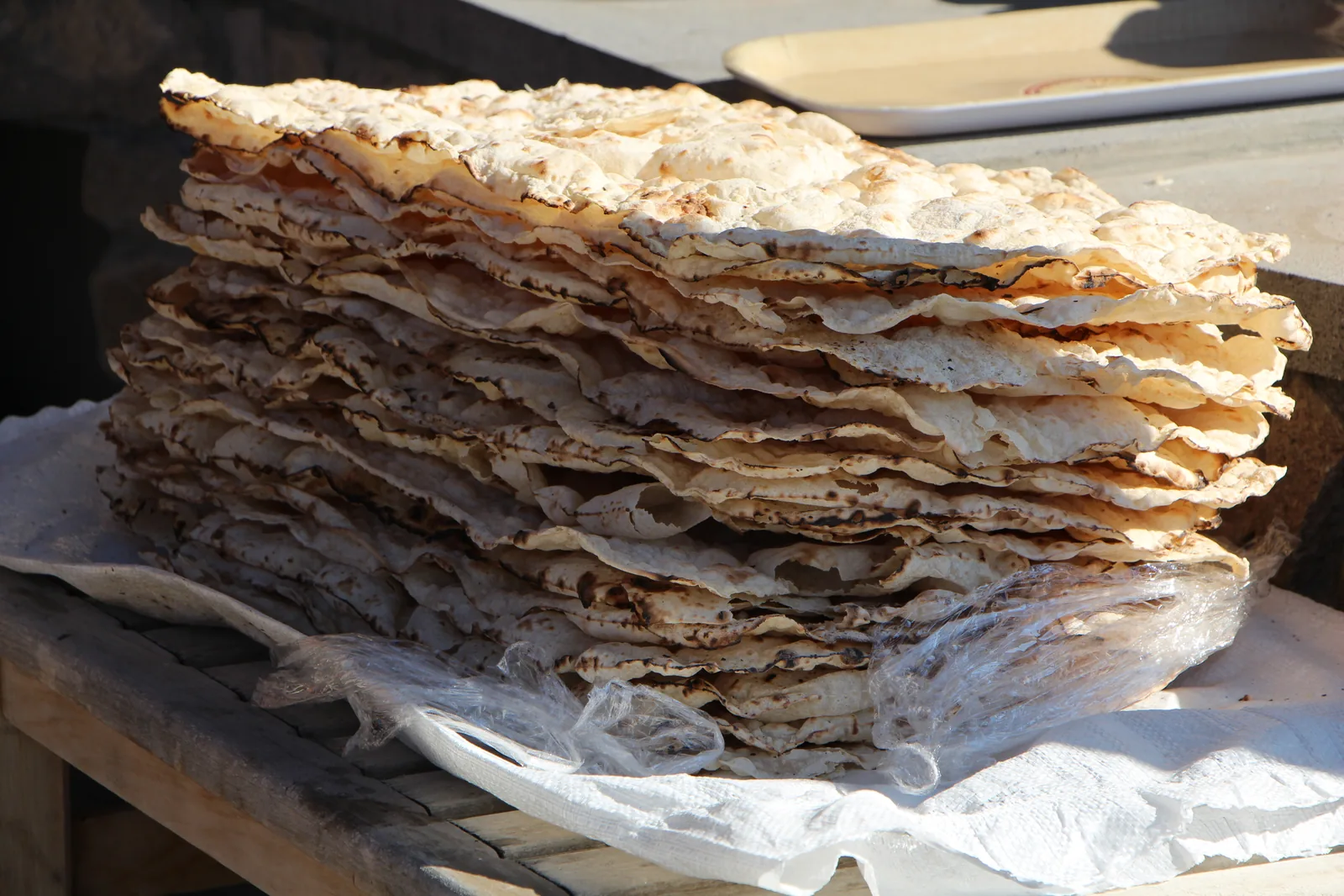 Stack of freshly baked Armenian lavash — thin unleavened flatbread baked in a traditional tonir clay oven — part of the UNESCO intangible cultural heritage inscription of flatbread-making cultures inscribed 2016