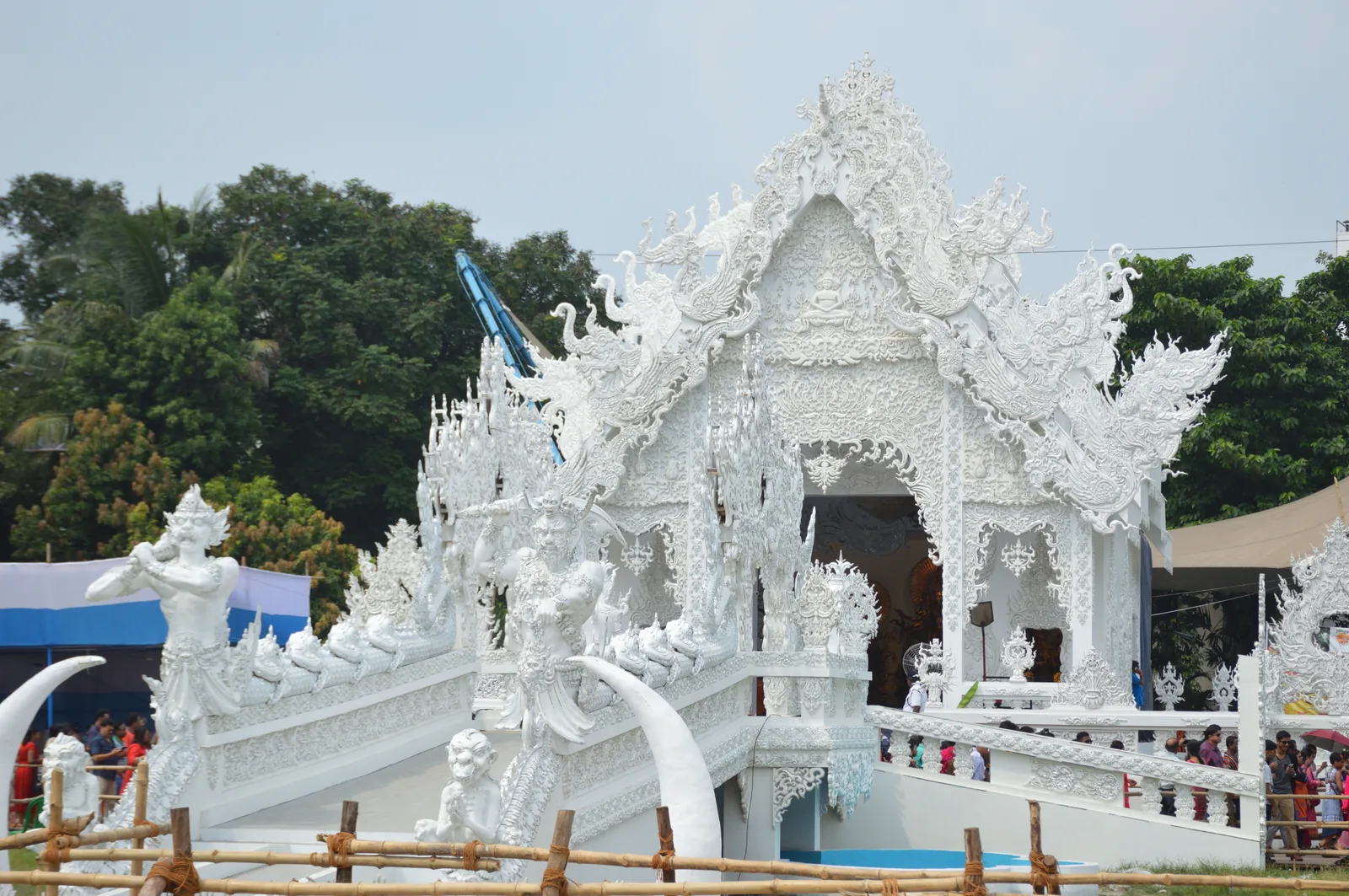Elaborately decorated white Durga Puja pandal at Ballygunge Sarbojanin Durgotsab festival in Kolkata with visitors — UNESCO inscribed Durga Puja in Kolkata (File 00703, 2021) recognizing how the festival transformed from domestic religious observance into a public art event drawing 2.5 million visitors across 45,000 pandals annually