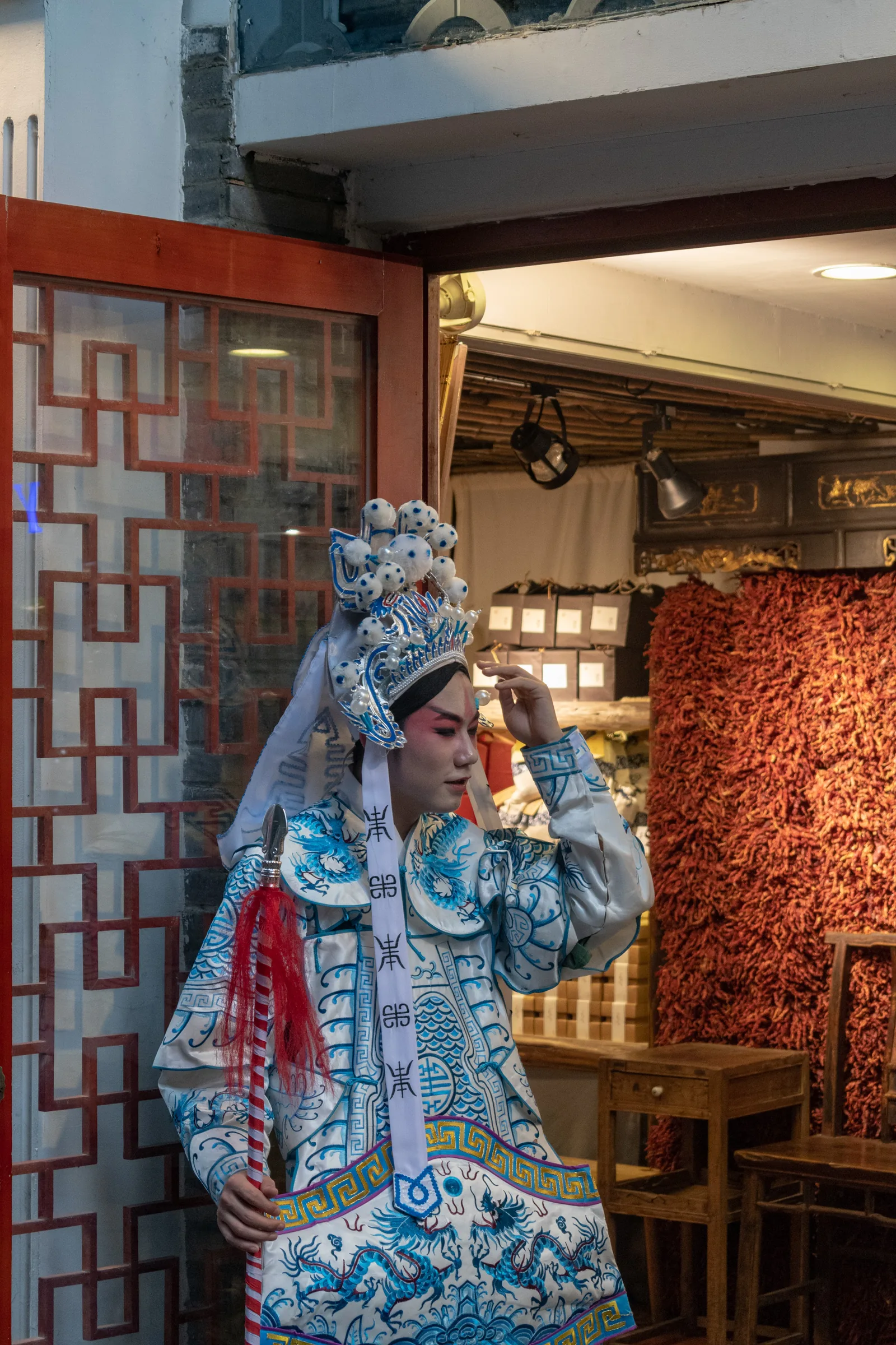 Sichuan Opera performer in elaborate traditional blue-and-white costume with theatrical face makeup in Chengdu — recognized on China's national ICH list in May 2006