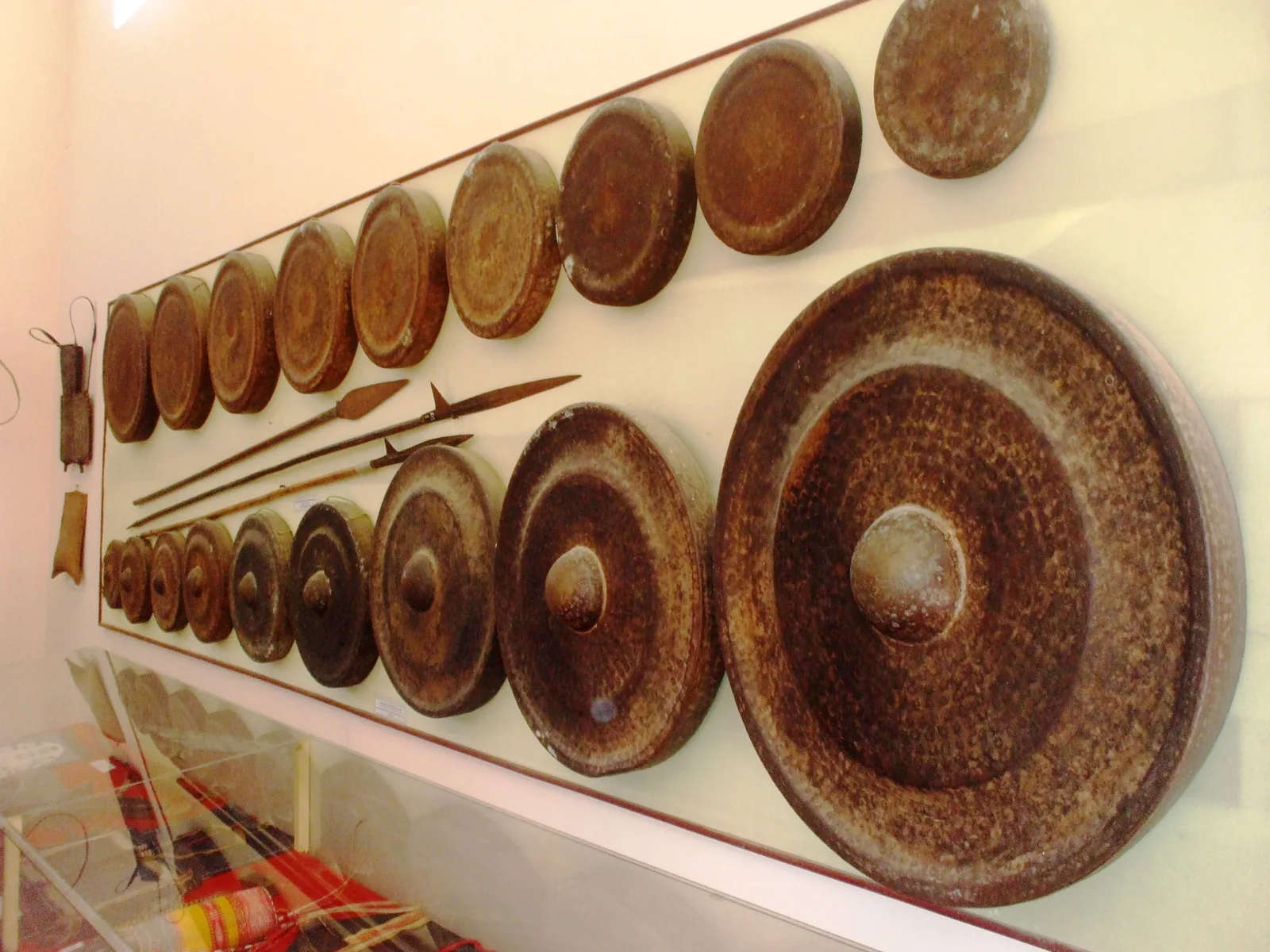 Vietnamese cồng chiêng (gong set) displayed at the Quang Trung Museum, Vietnam — ranging from flat gongs to bossed gongs of varying sizes; the Space of Gong Culture in the Central Highlands of Vietnam (File 00120) is inscribed on UNESCO's Representative List of the Intangible Cultural Heritage of Humanity